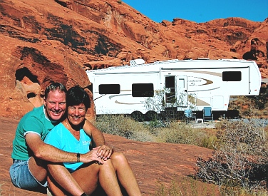 Mark & Emily Fagan with our rolling hom in Valley of Fire State Park, Nevada.