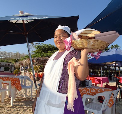 Vendor sells corn bread on the beach Huatulco