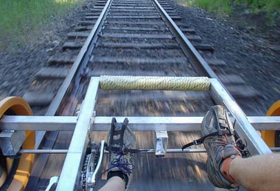 Two feet pedaling the rail riding bike