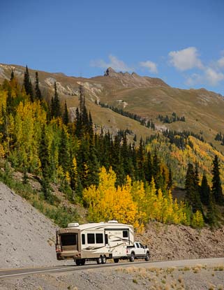 A fifth wheel RV starts over Red Mountain Pass in Colorado