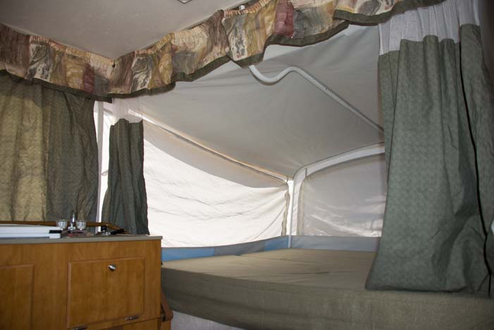 Inside popup tent trailer RV queen size bed slide