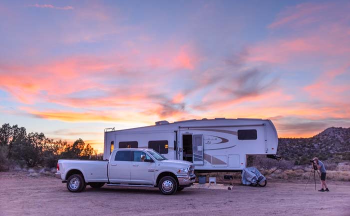 Truck and fifth wheel trailer RV at sunset