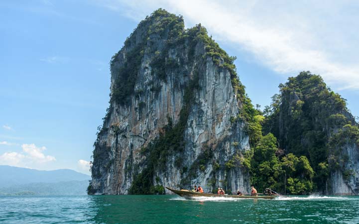 Limestone karst Longtail boat Khao Sok National Park Thailand Cheow Lan Lake Chiewlarn Lake longtail boat