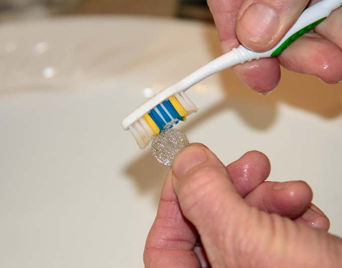 Use toothbrush to clean RV faucet screen
