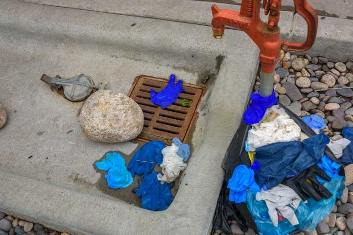 Discarded disposable gloves at RV dump station-min