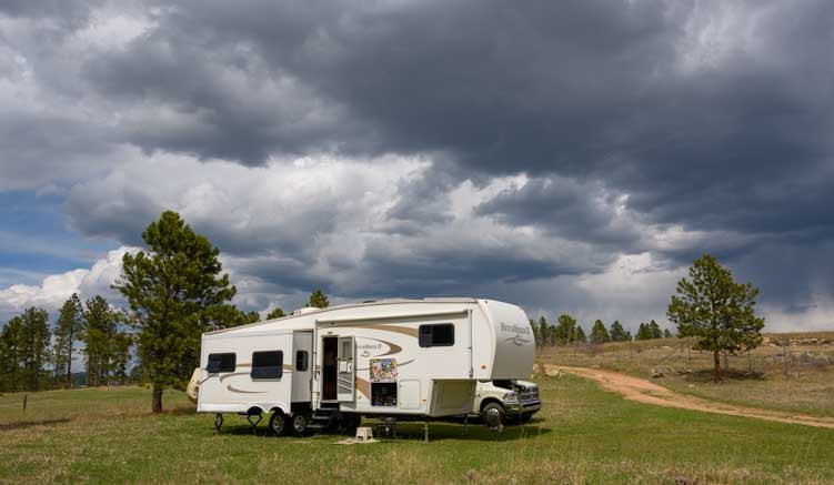 Storm clouds ofver fifth wheel RV in South Dakota-min