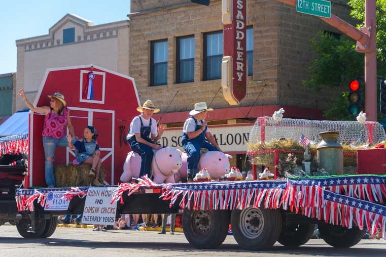 Riding hogs and chasing chicks 4th of July parade Cody Wyoming-min