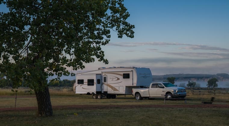 RV fifth wheel camping at dusk-min