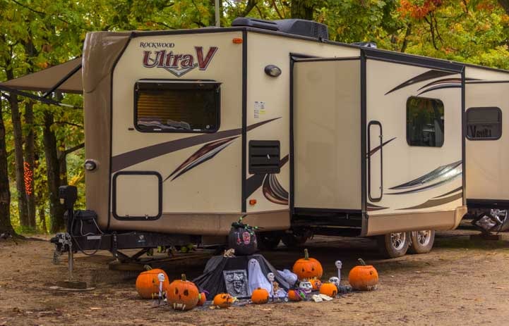 RV camper with Halloween pumpkins-min