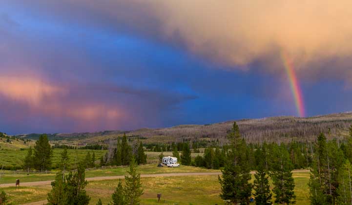 RV with rainbow and stormy sky