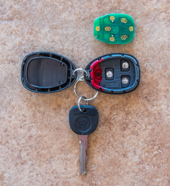 Car key fob opened up with the electrical contacts exposed