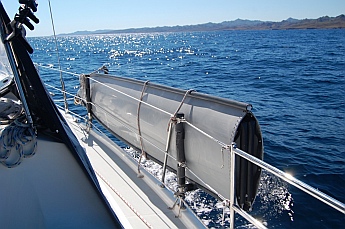 Porta-bote hull mounted on the lifelines of a sailboat
